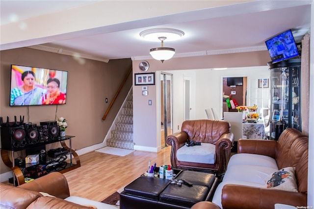 living room featuring hardwood / wood-style flooring and ornamental molding