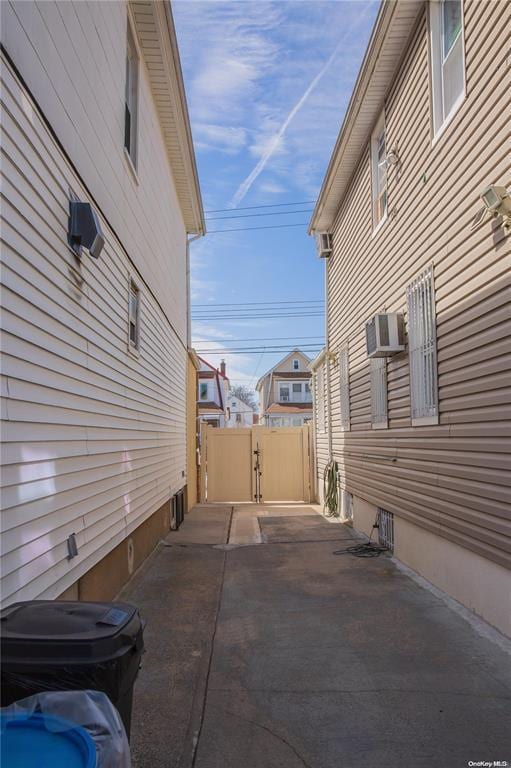 view of side of property with an AC wall unit