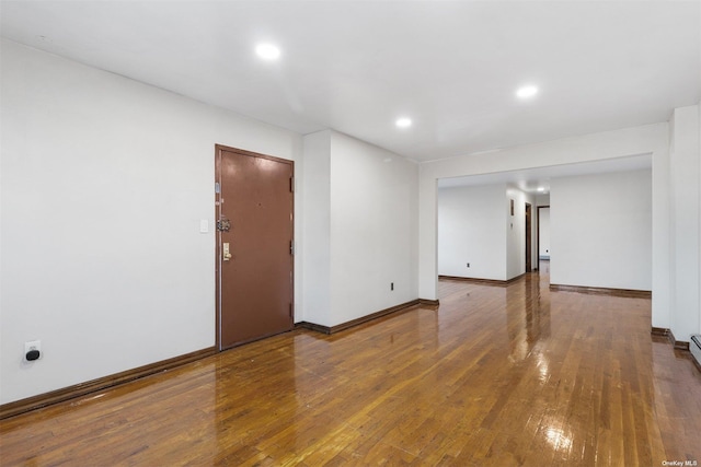 unfurnished room with hardwood / wood-style flooring