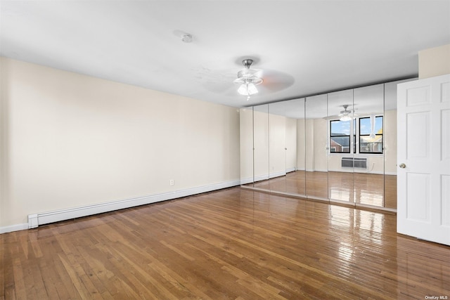 unfurnished living room with ceiling fan, a baseboard radiator, and hardwood / wood-style flooring