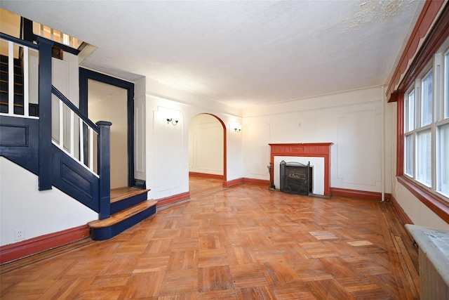 unfurnished living room with light parquet floors