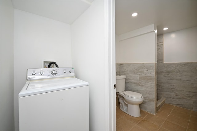 laundry area featuring tile patterned flooring, washer / dryer, and tile walls