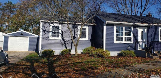 view of side of home with a garage and an outdoor structure