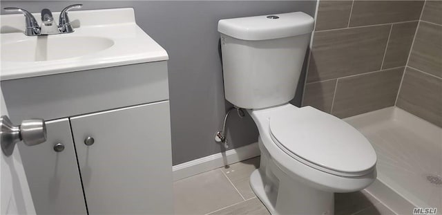 bathroom featuring toilet, vanity, and tile patterned floors