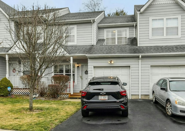 townhome / multi-family property with a front yard and a garage