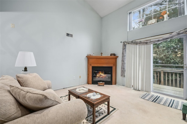 living room with carpet floors and high vaulted ceiling