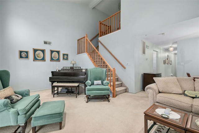 carpeted living room featuring beam ceiling and high vaulted ceiling