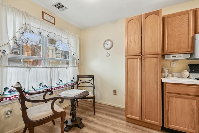 kitchen with white range oven and light hardwood / wood-style flooring