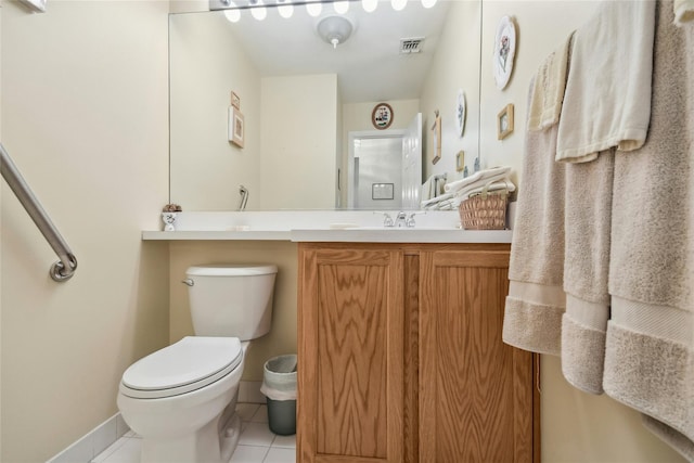 bathroom with tile patterned flooring, vanity, and toilet