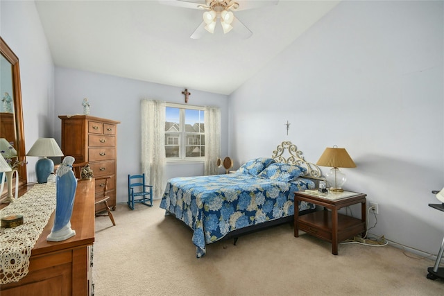 bedroom with ceiling fan, light colored carpet, and vaulted ceiling