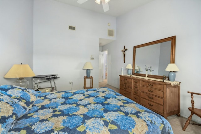 bedroom with ceiling fan, a towering ceiling, and light colored carpet