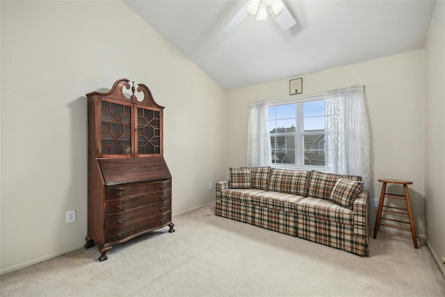 living area with light carpet, vaulted ceiling, and ceiling fan