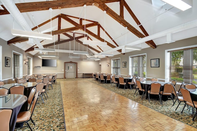 interior space with light parquet floors, high vaulted ceiling, and beam ceiling