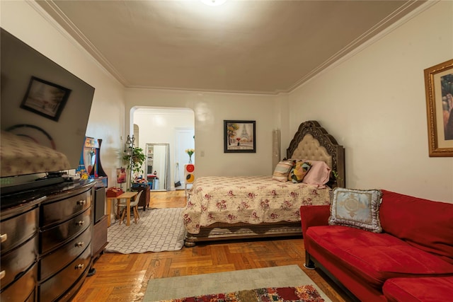 bedroom with crown molding and parquet floors