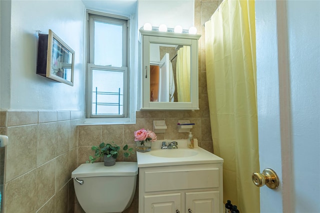 bathroom with vanity, toilet, and a wealth of natural light