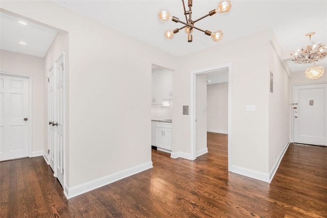 interior space with dark hardwood / wood-style flooring and a notable chandelier