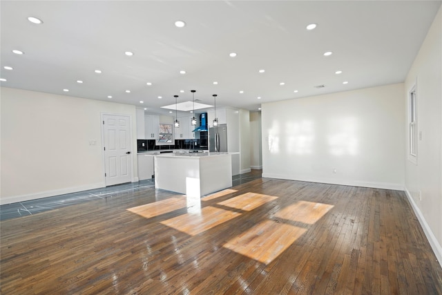 unfurnished living room featuring dark hardwood / wood-style floors