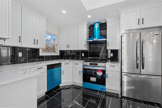 kitchen featuring white cabinets, wall chimney exhaust hood, and stainless steel appliances