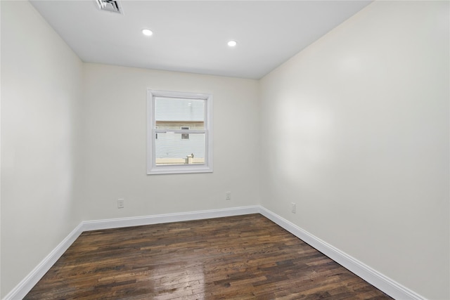 empty room featuring dark wood-type flooring