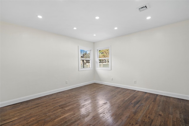 spare room featuring dark hardwood / wood-style floors