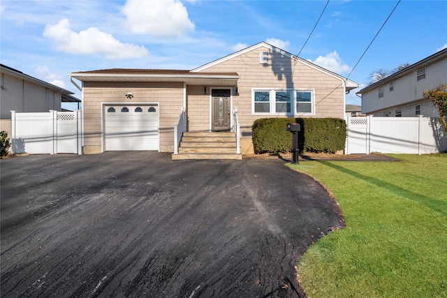 view of front of home featuring a garage and a front lawn