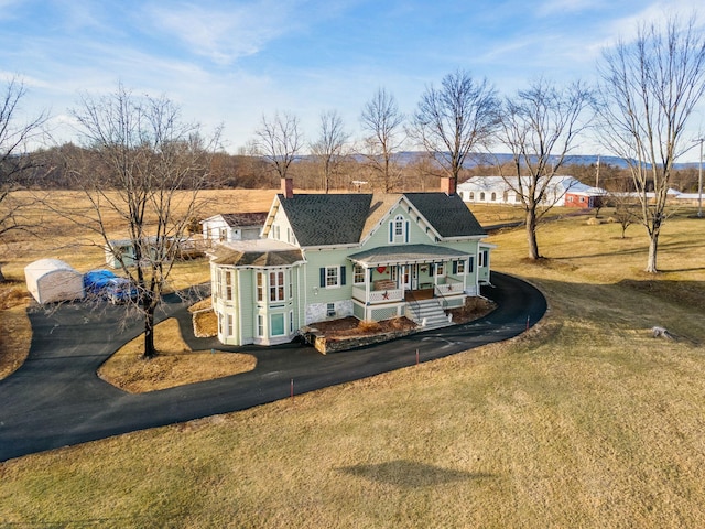 exterior space featuring a porch and a yard