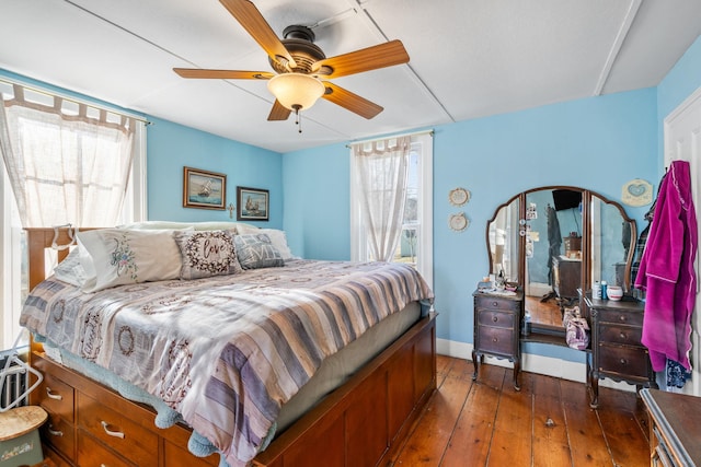 bedroom with ceiling fan and dark wood-type flooring