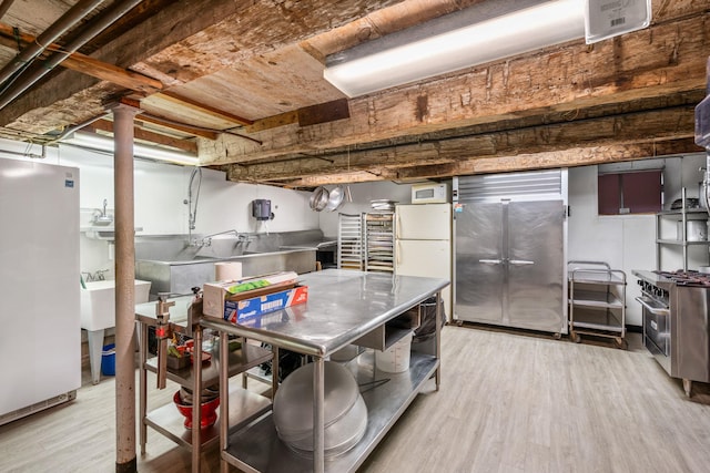 kitchen featuring light wood-type flooring and premium appliances