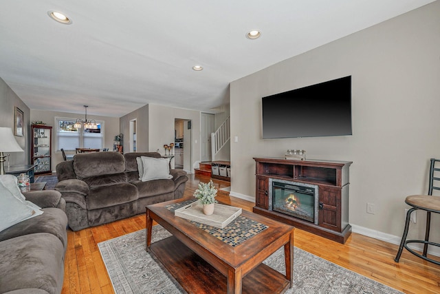 living room featuring light hardwood / wood-style floors and an inviting chandelier