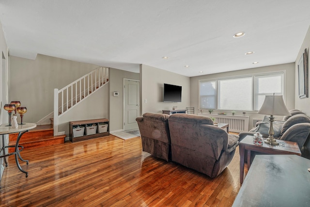 living room featuring wood-type flooring and radiator