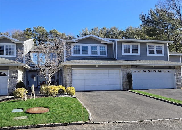 front of property featuring a front yard and a garage