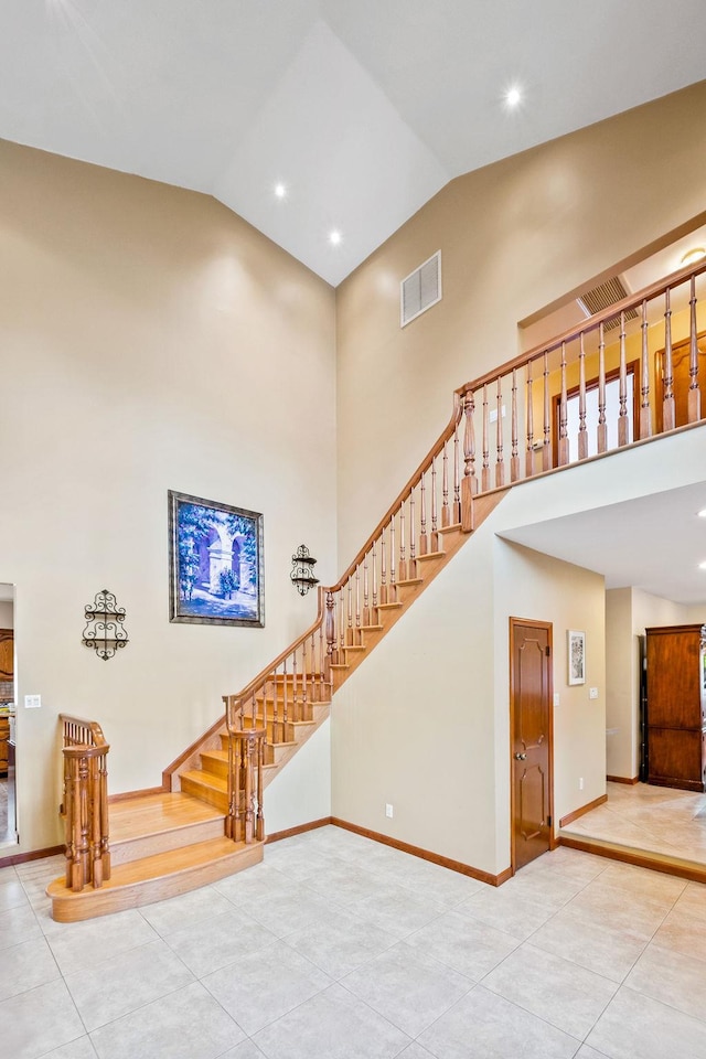 living room with high vaulted ceiling and tile patterned flooring