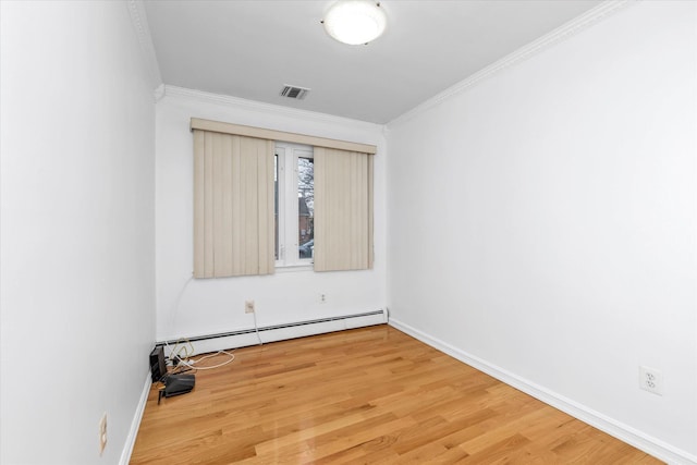 unfurnished room featuring a baseboard heating unit, crown molding, and wood-type flooring