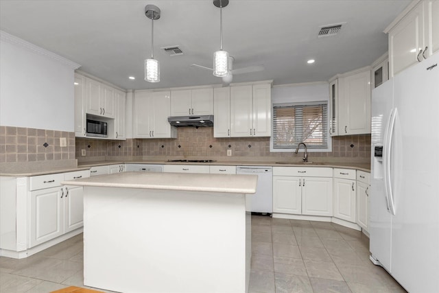 kitchen featuring a kitchen island, white cabinetry, white appliances, and hanging light fixtures