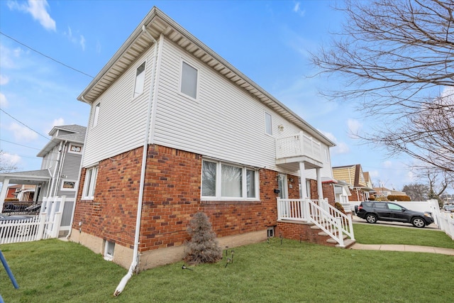 view of side of property with a lawn