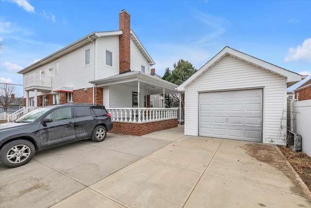 view of home's exterior with covered porch, a garage, and an outdoor structure