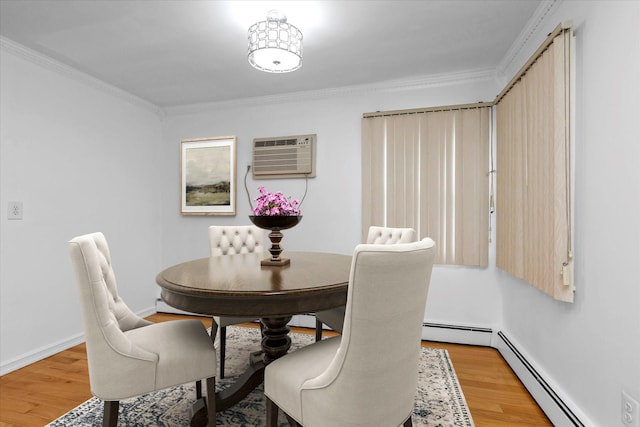 dining area with light wood-type flooring, a baseboard heating unit, and ornamental molding