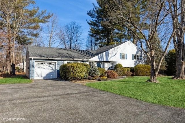 view of front facade with a front yard and a garage