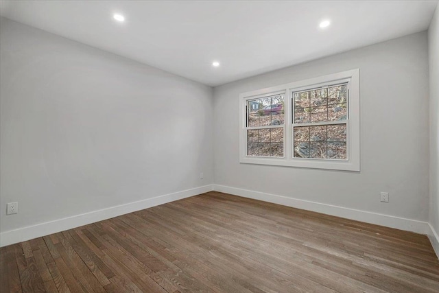 unfurnished room featuring hardwood / wood-style flooring