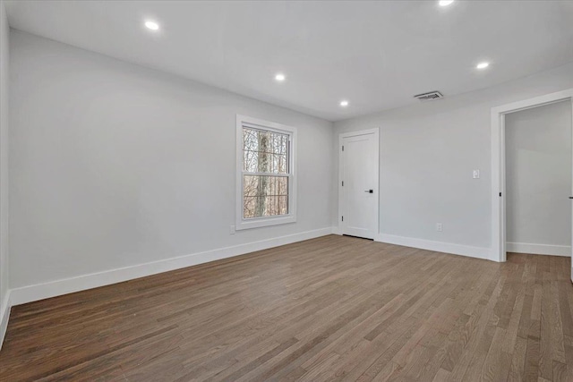 unfurnished room featuring hardwood / wood-style floors