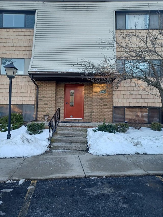 view of snow covered property entrance