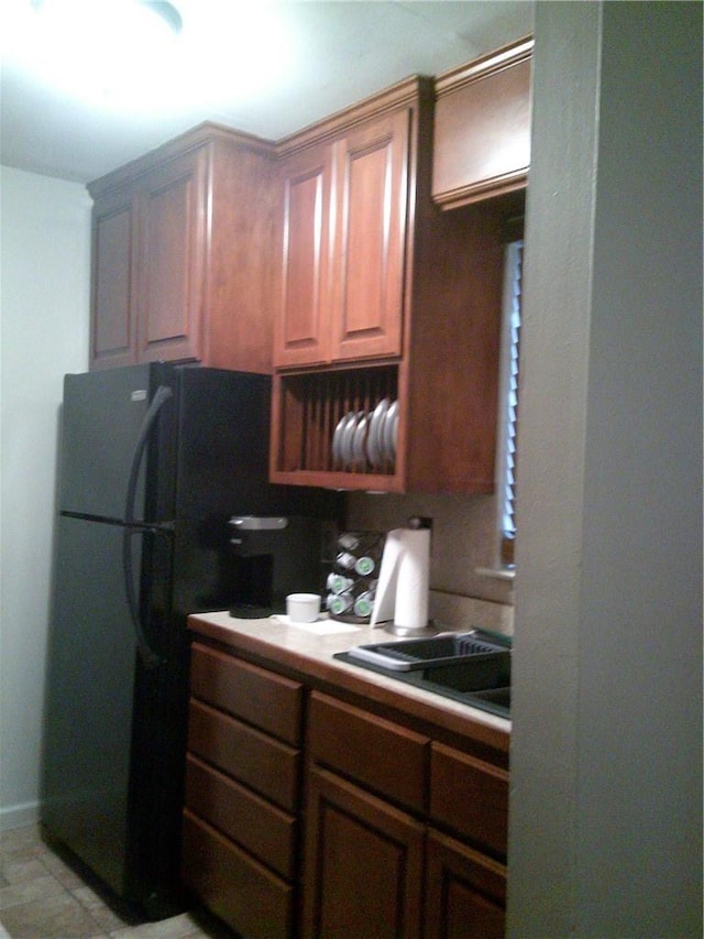 kitchen featuring sink and black refrigerator