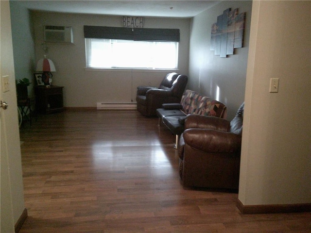 living area featuring a baseboard radiator, a wall mounted air conditioner, and dark hardwood / wood-style flooring