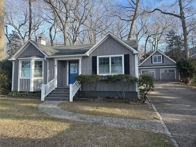 view of front of property with a garage and an outdoor structure