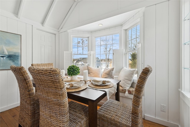 sunroom / solarium featuring vaulted ceiling with beams