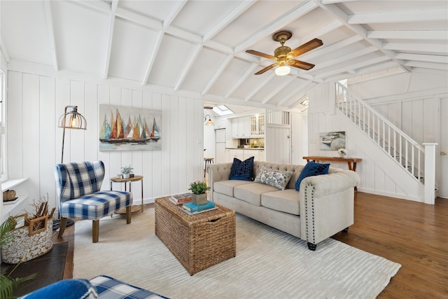 living room featuring ceiling fan, hardwood / wood-style flooring, and lofted ceiling