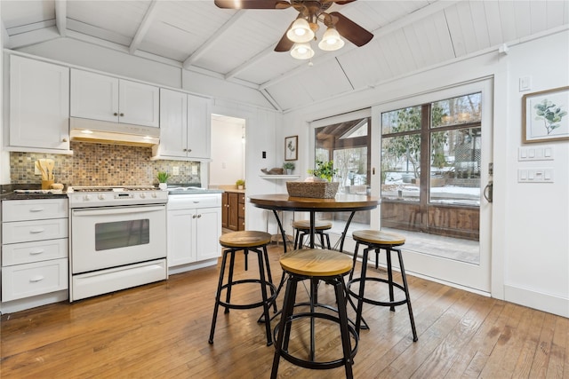 kitchen with white cabinetry, white range with electric cooktop, decorative backsplash, light hardwood / wood-style floors, and lofted ceiling with beams