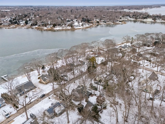 snowy aerial view with a water view