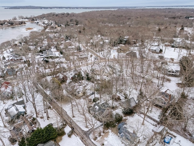 snowy aerial view featuring a water view