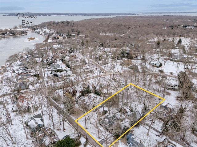 snowy aerial view featuring a water view